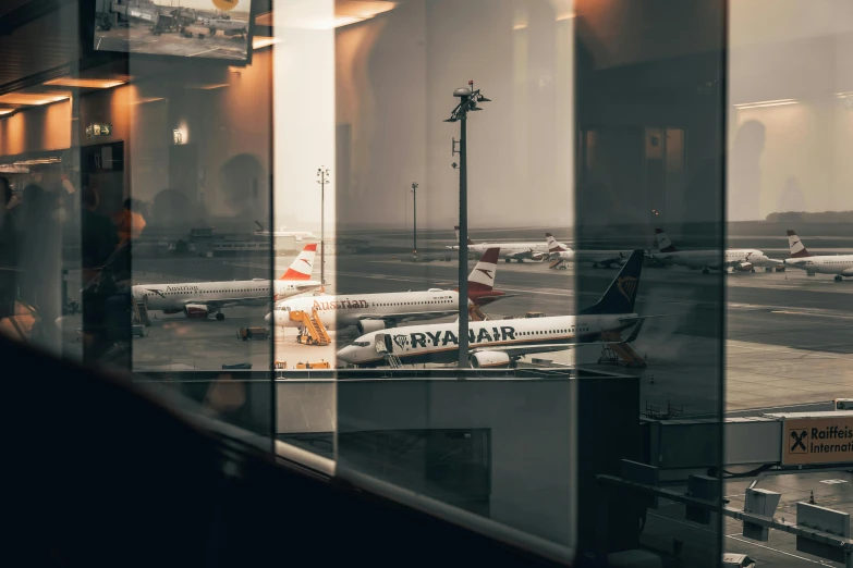 airport with a bunch of airplanes seen through the windows