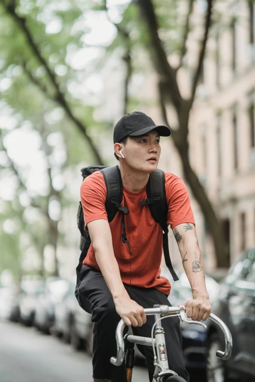 a man with a backpack on is riding his bicycle down the street