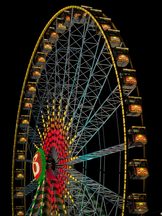 a ferris wheel is lit up and decorated with light bulbs