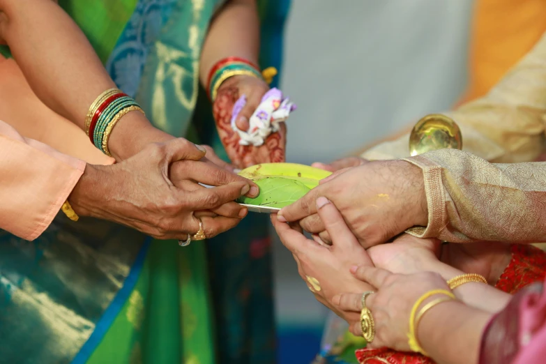 people are holding hands around a plate