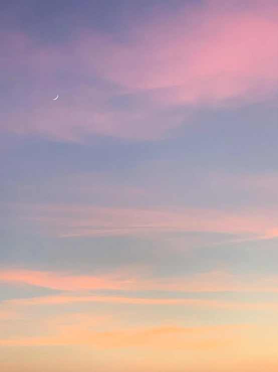 a lone boat in the distance and a plane flying above