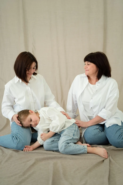 a family posing in a studio with one baby