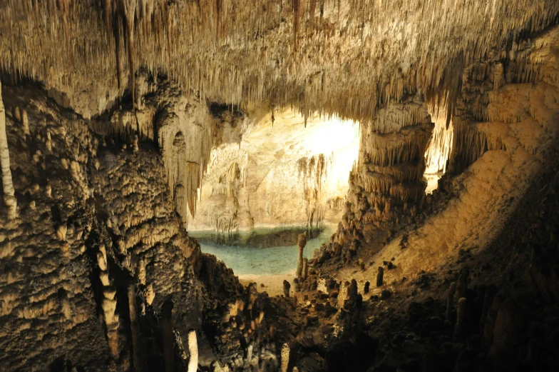 inside of a cave with lots of stalate hanging from the ceiling