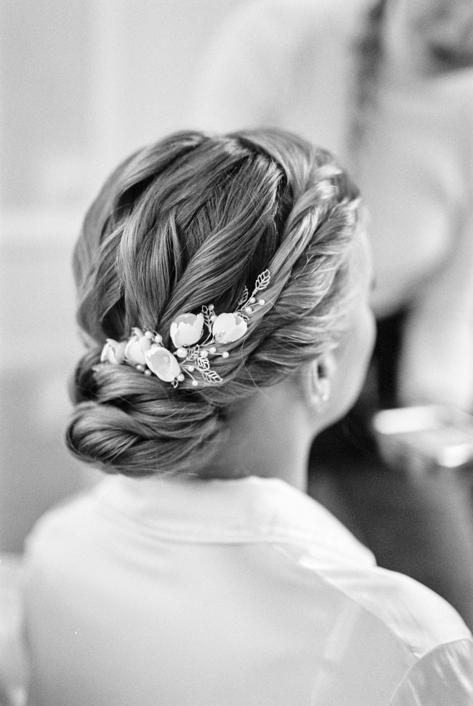 black and white po of a bride's id and flowers in her hair