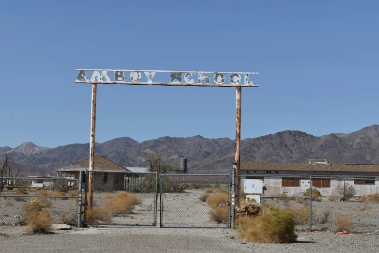 an old, run down motel sits in the middle of a desert