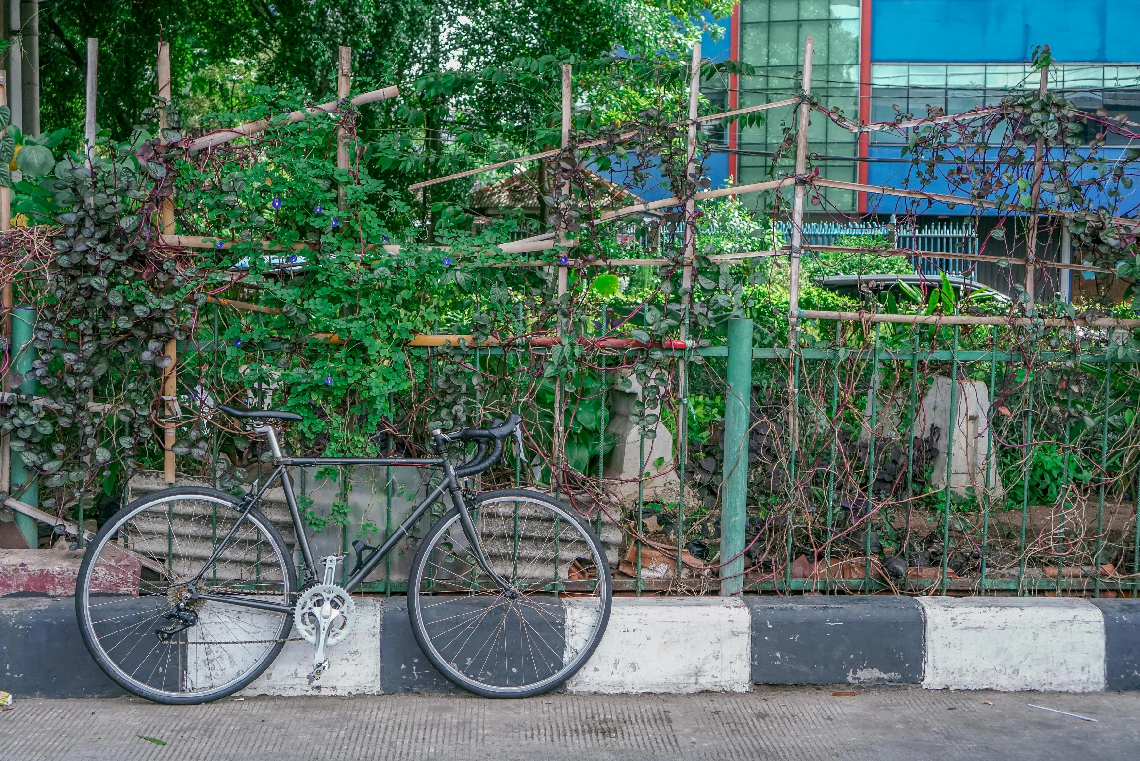 there is a bike leaning against the fence