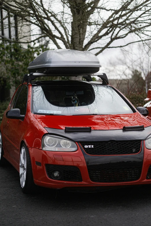 the red car is with the roof rack down