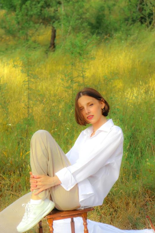 a young woman wearing shoes posing in a meadow