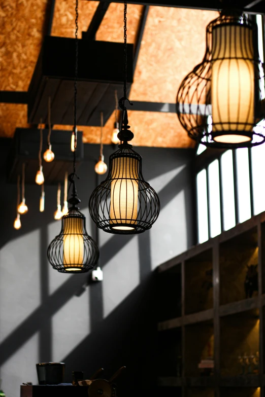 a group of small lanterns that are hanging from a ceiling