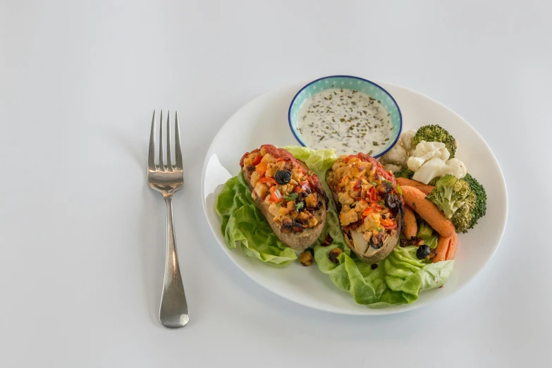 a white plate topped with vegetables and meat