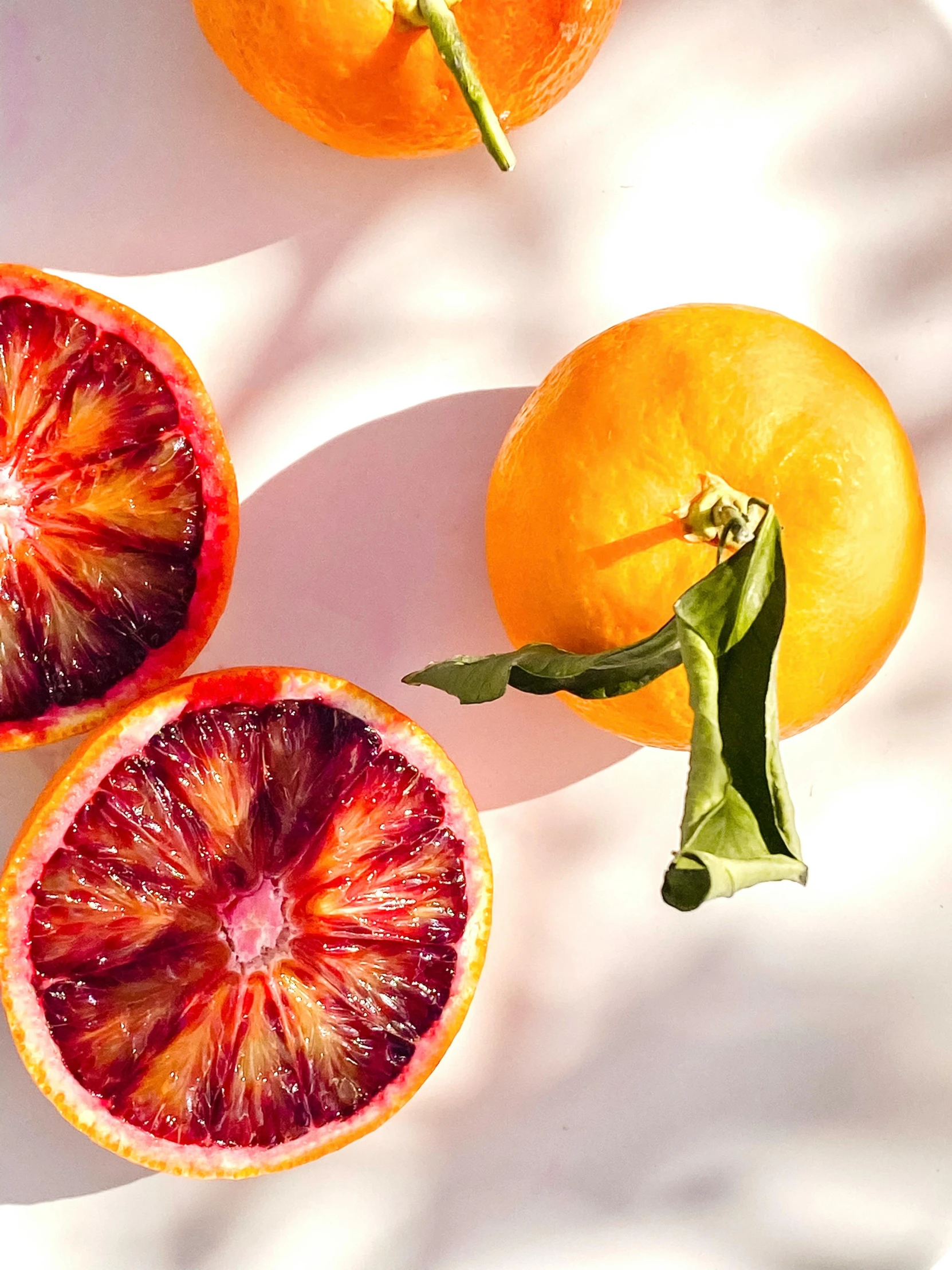 two halves of gfruit sitting on a white table