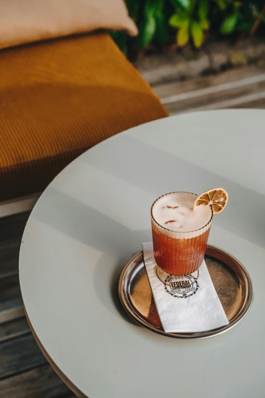 an orange slice in a small cup on a saucer