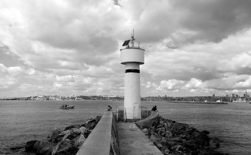 a lighthouse on a pier near some water