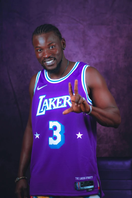 man making peace sign in lakers jersey