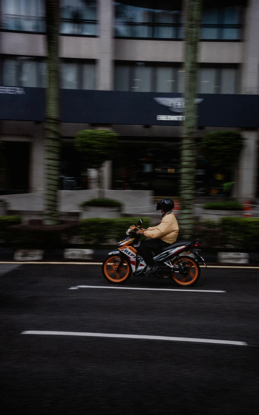 man riding on his motor cycle across the street