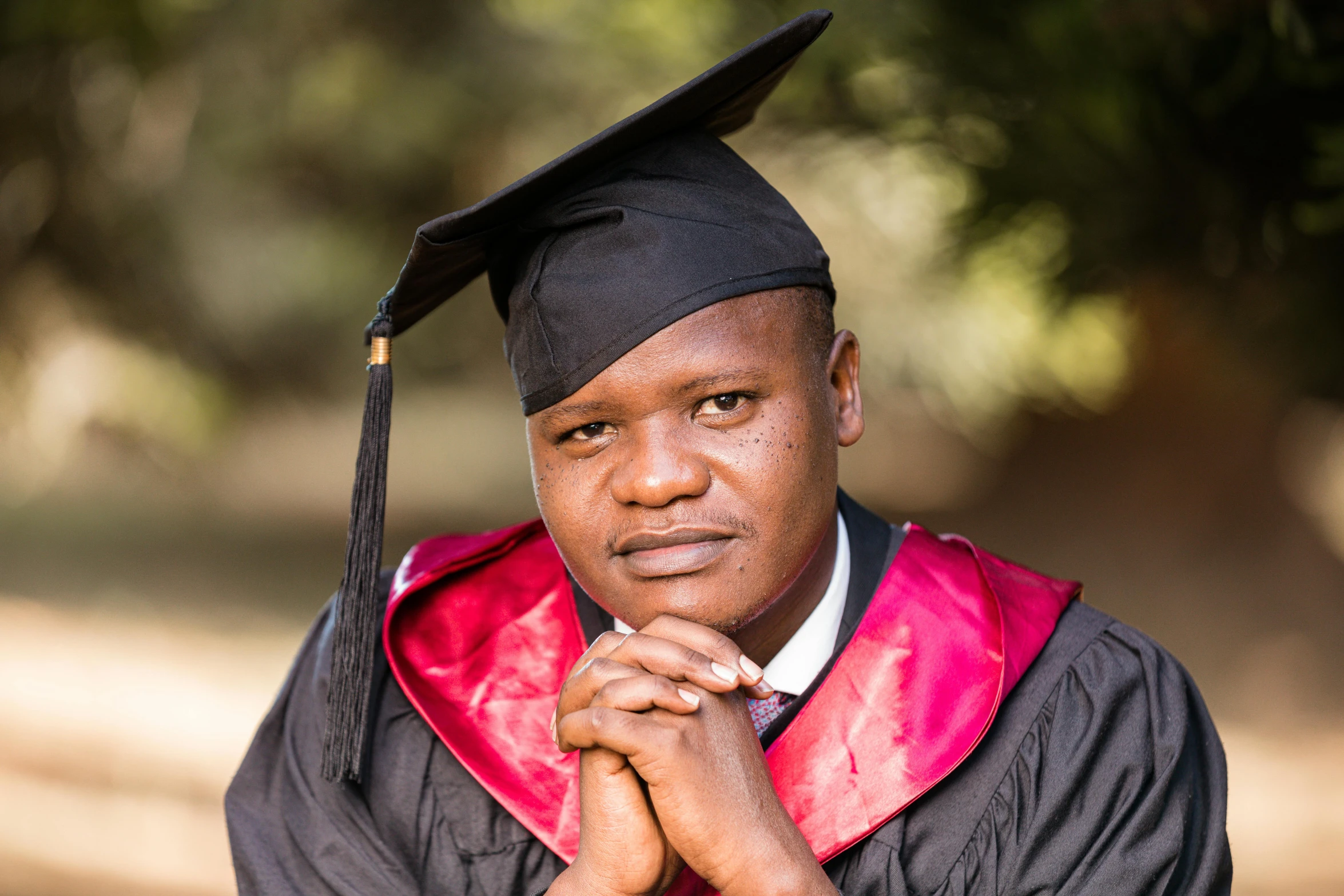 a person in a graduation gown posing for a picture