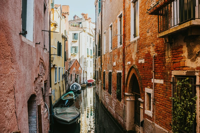 several buildings line the river with a boat