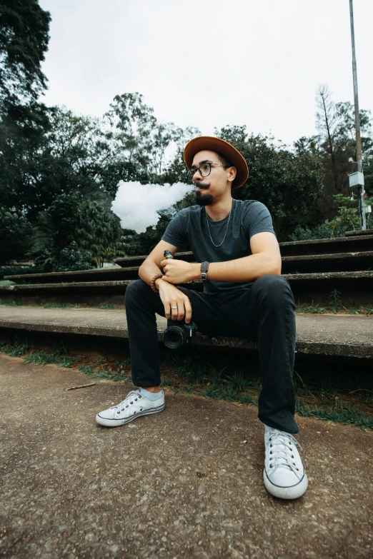 a man sitting on stairs with a pipe in his mouth