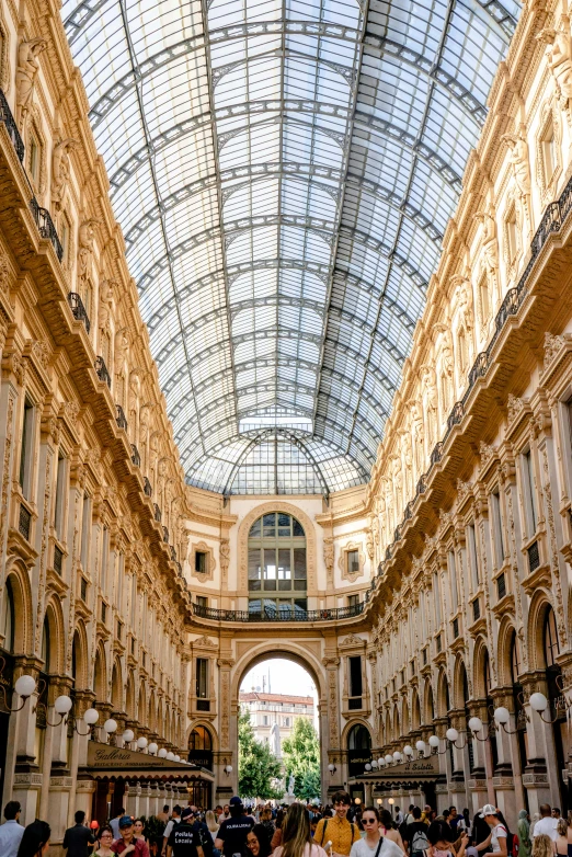 the view inside of an shopping mall, with several people walking by