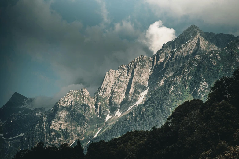 a mountain scene with a lot of clouds overhead