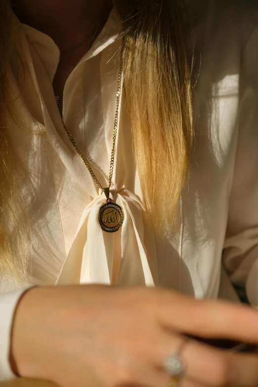 a woman that is sitting down with a necklace