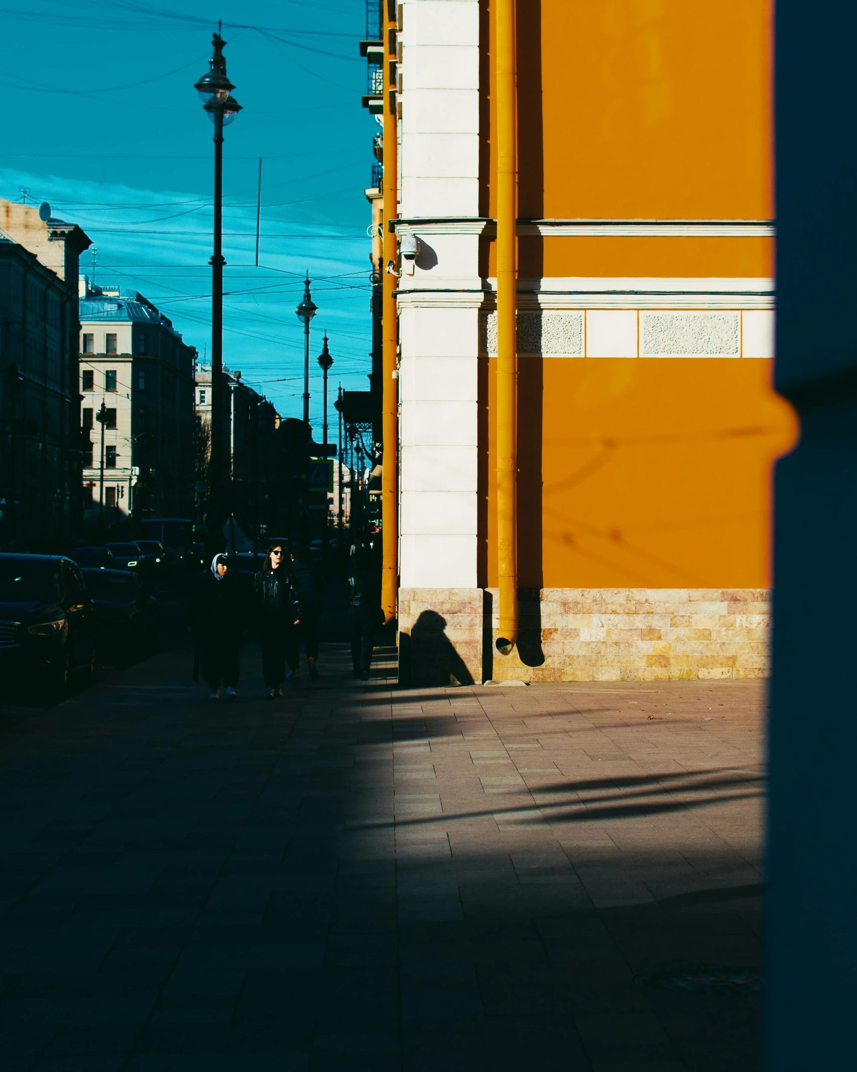 people walking down the sidewalk near tall buildings