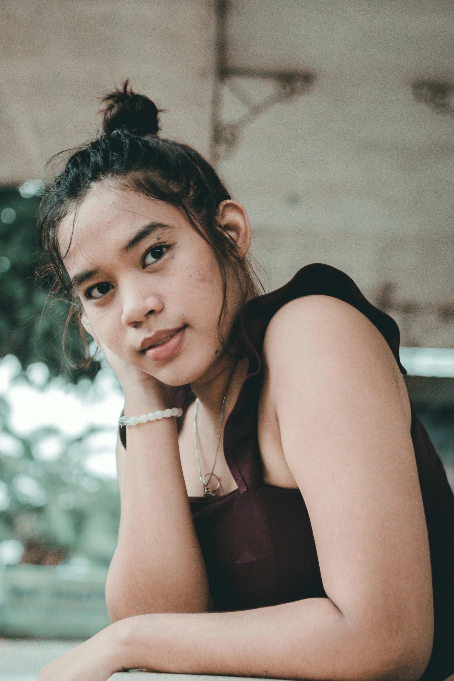 young woman posing with hands on face for picture