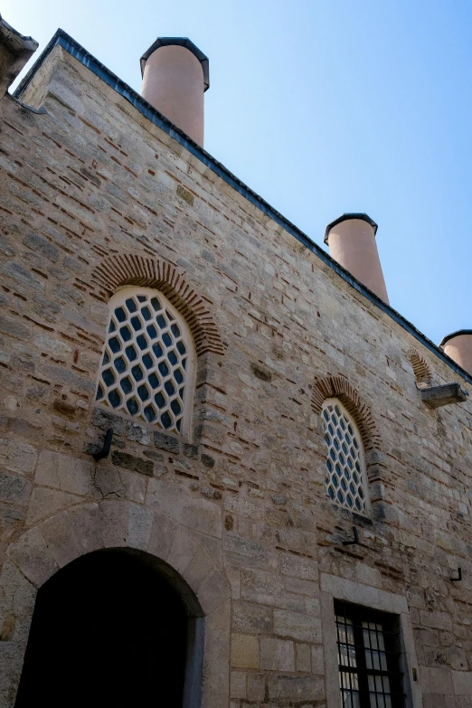 some brick buildings with three arched windows next to each other