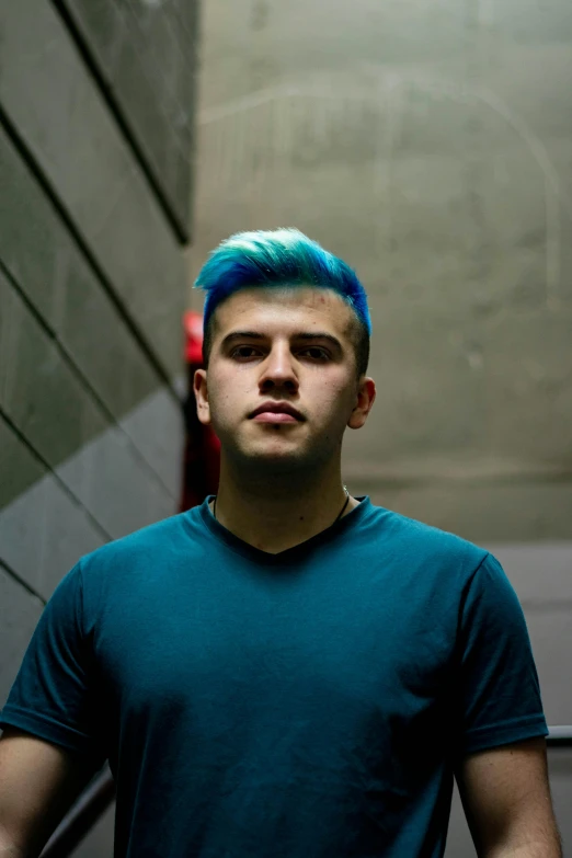 a man with bright hair and a blue shirt