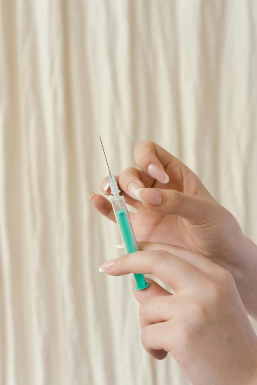 a woman holding an ointment to her hand