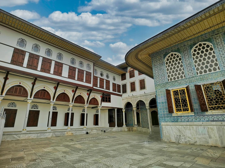 a courtyard in a multistory building with an elaborate wall