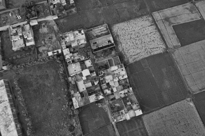 the aerial view shows a small farm area