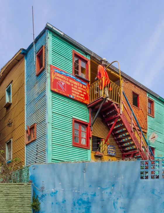 the building is very colorful with red railings