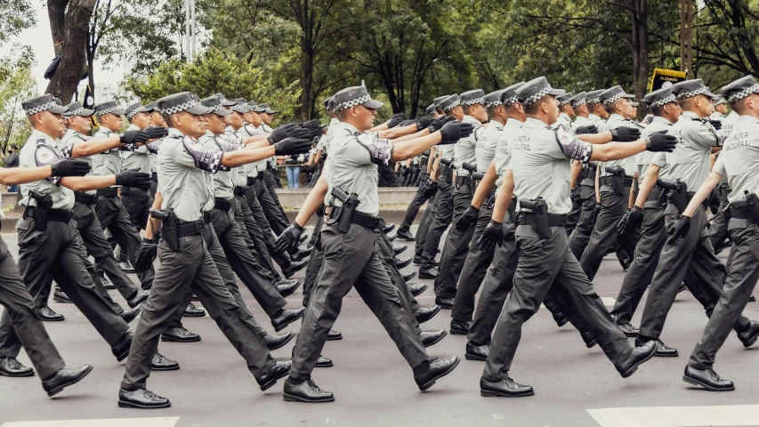 many police officers in uniform marching in a parade