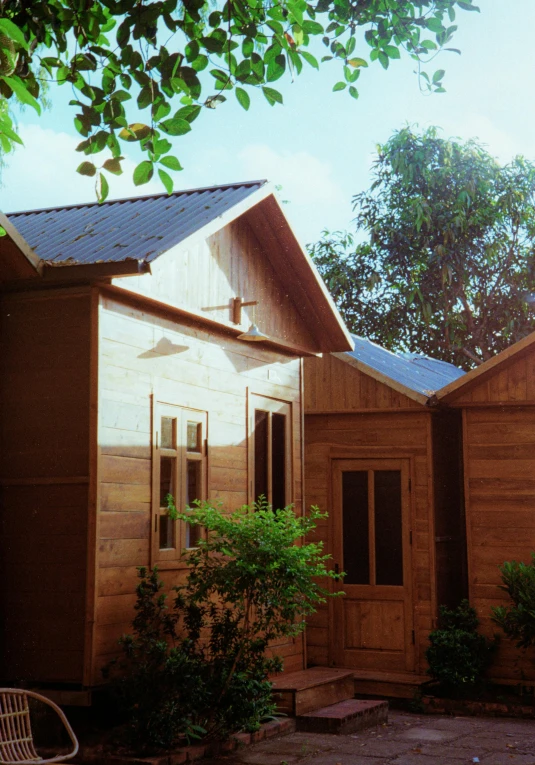 wooden buildings with a small patio area and a chair