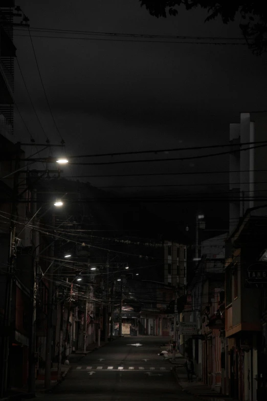 the dark night sky is above a run down alleyway