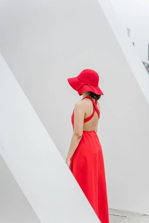 a woman wearing red walks on a stairs