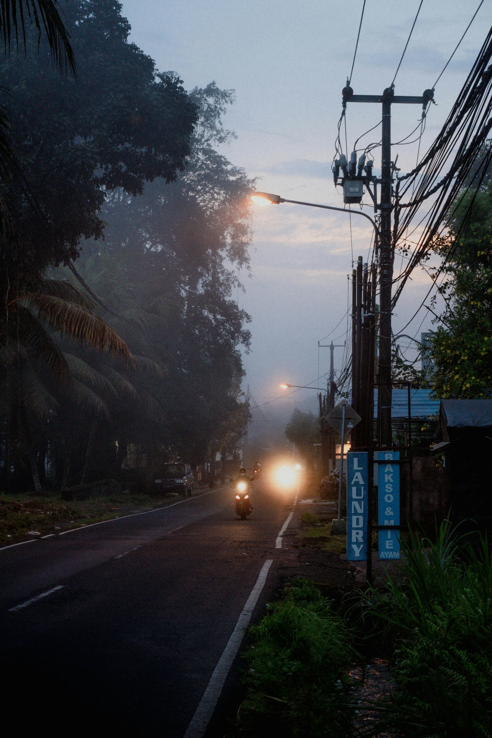 the car is driving down the road in the rain