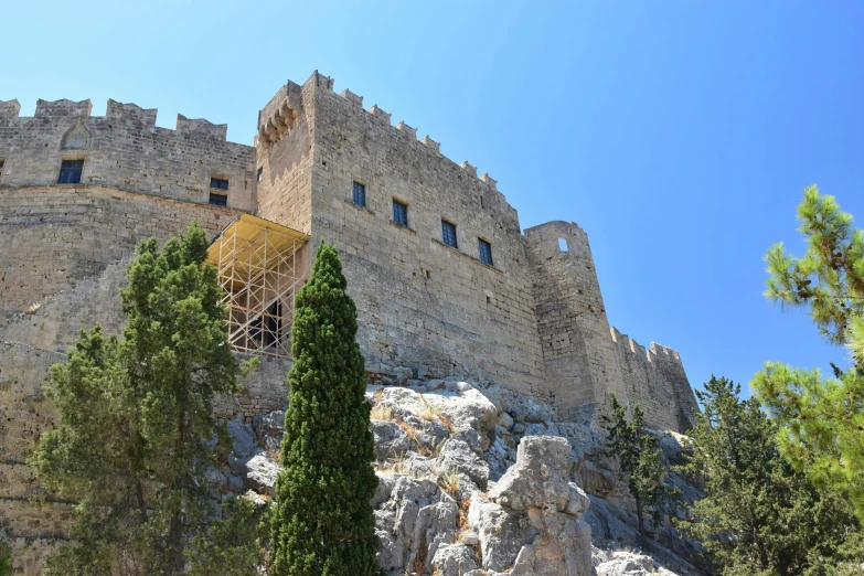 a castle with a yellow door is shown in the middle of the day