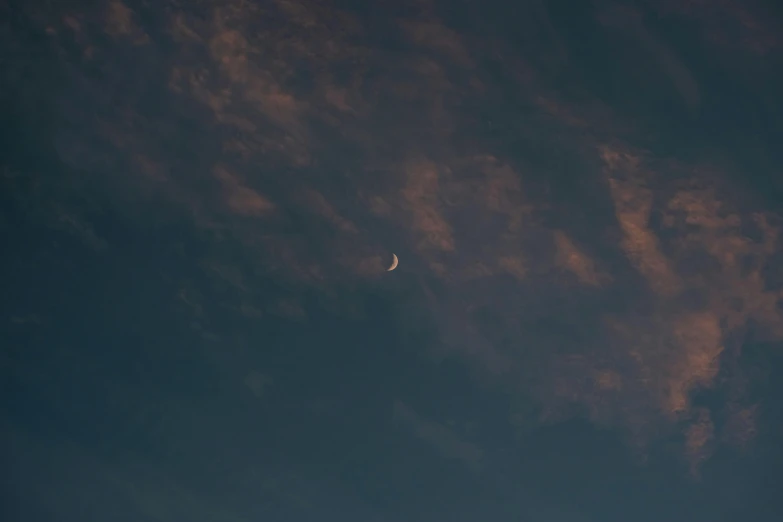 a jet flying in the sky with very little clouds