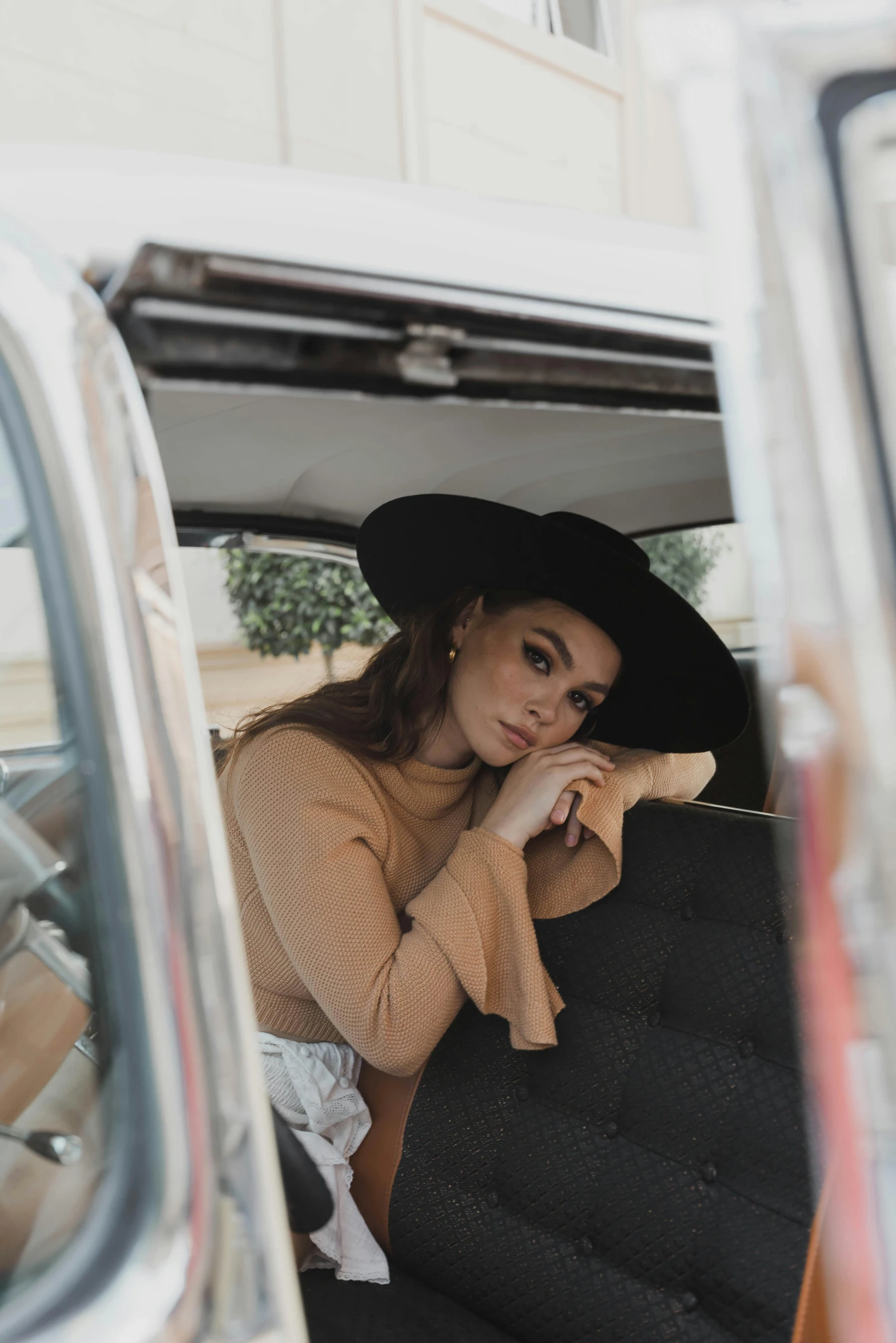 a woman wearing a black hat in a van