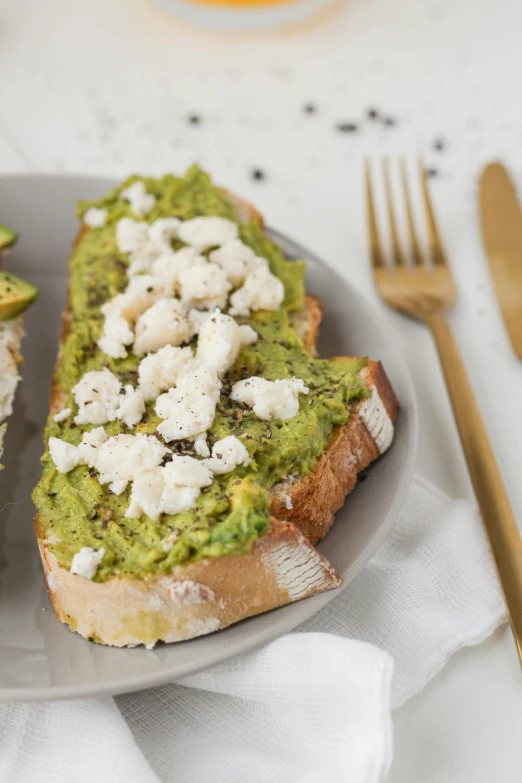 a plate that has two pieces of bread and a knife