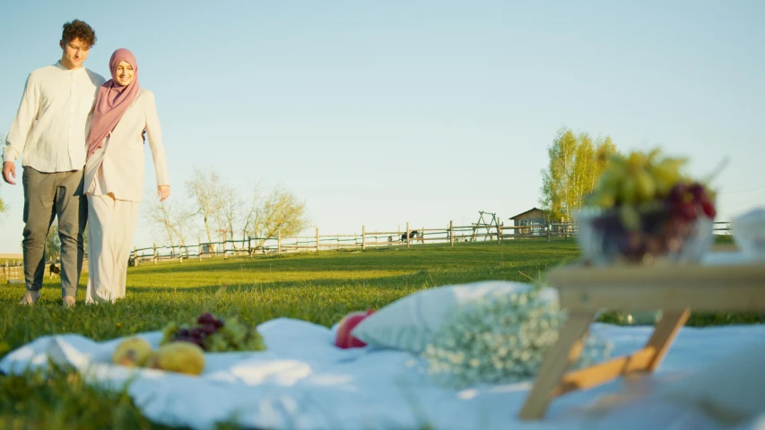 a couple standing near a lawn with a lawn chair