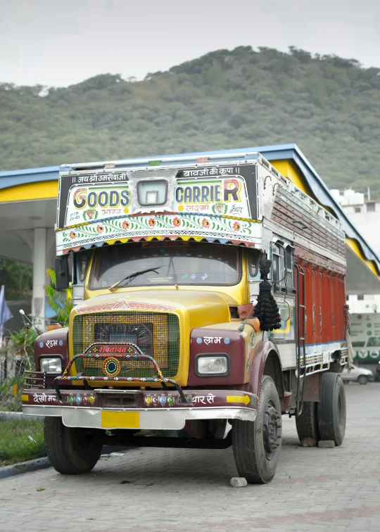 a semi truck parked next to an orange structure