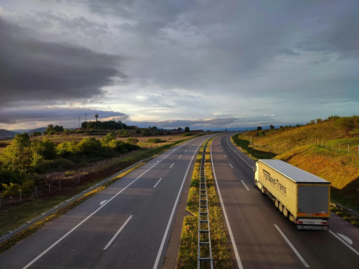 a large truck moving down an empty highway