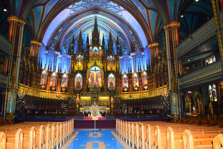 a tall cathedral with large towers and blue carpeting