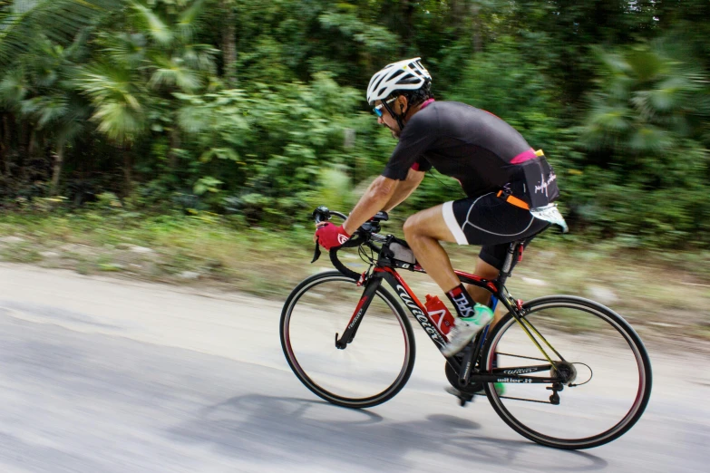 a man riding a bike down a road