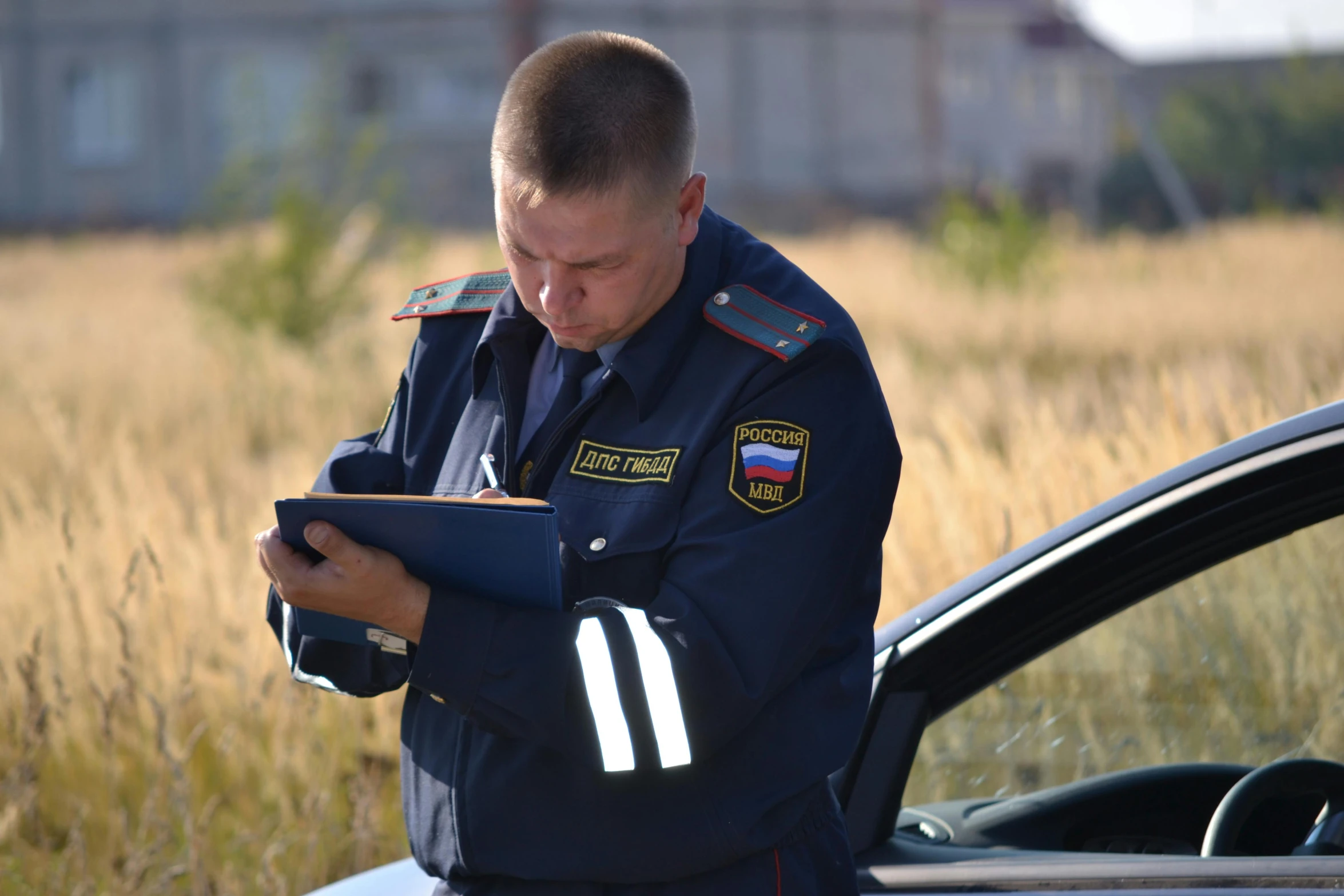 a man in military uniform reading in a field