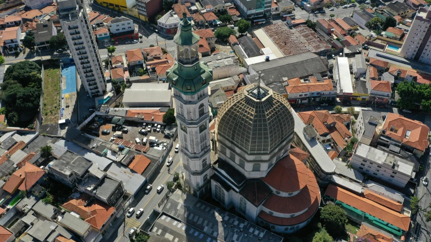 a large building with two towers next to a small city