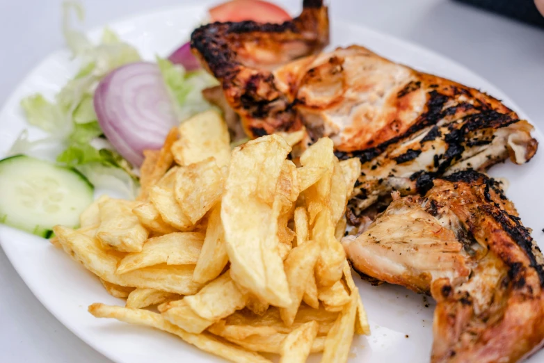 a white plate topped with food and fries